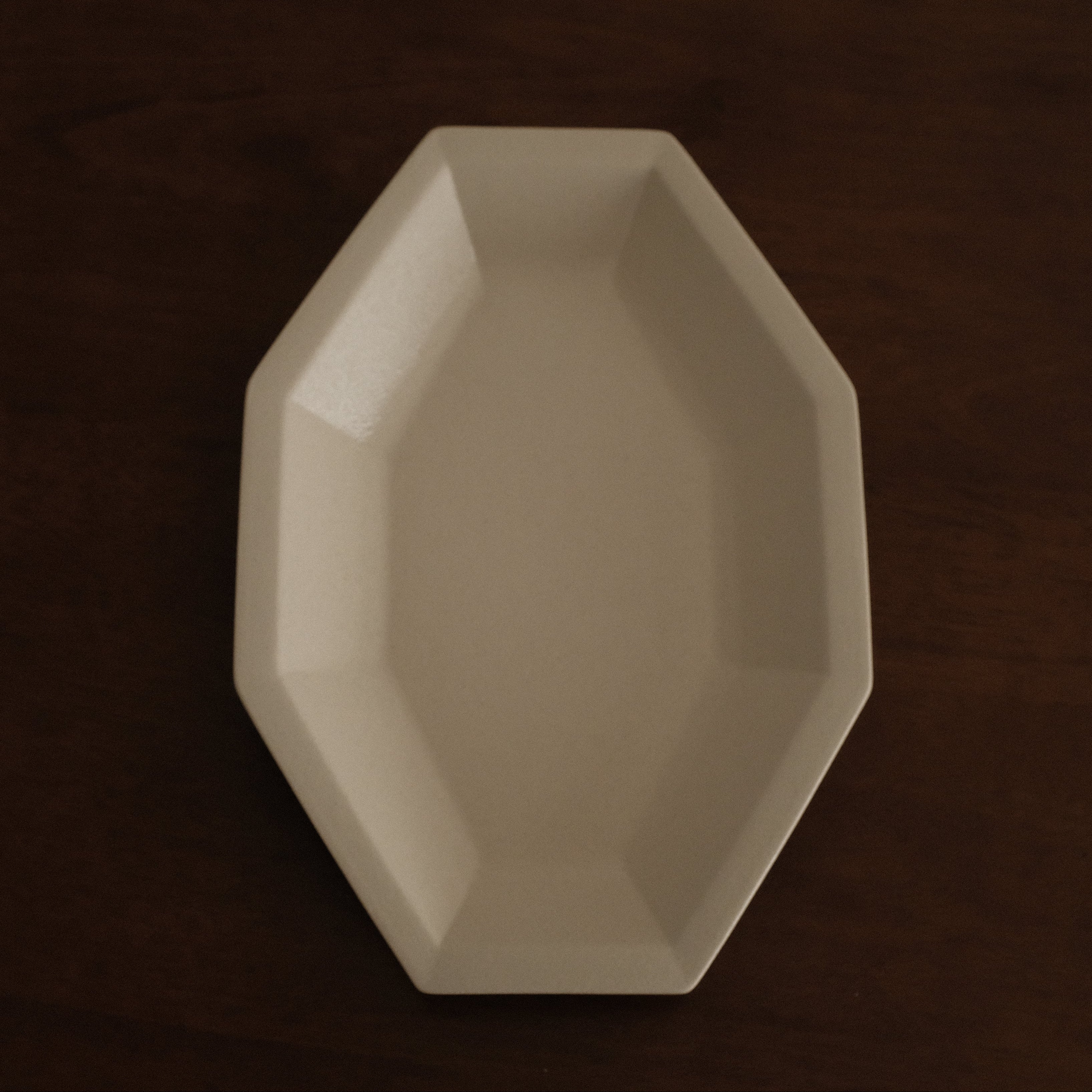 Beige octagonal dish on a dark brown background