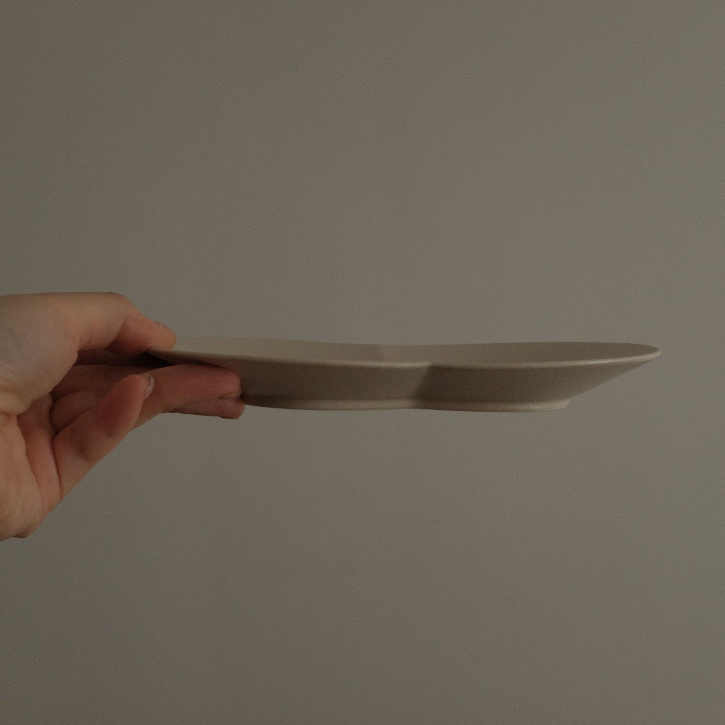 BLANCHETTE French Retro Ash White Two Petals Small Dish Plate Ceramic Underglazed Powdered Glaze Stoneware hand holding 