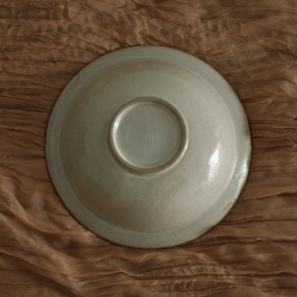 White ceramic bowl on a textured brown surface