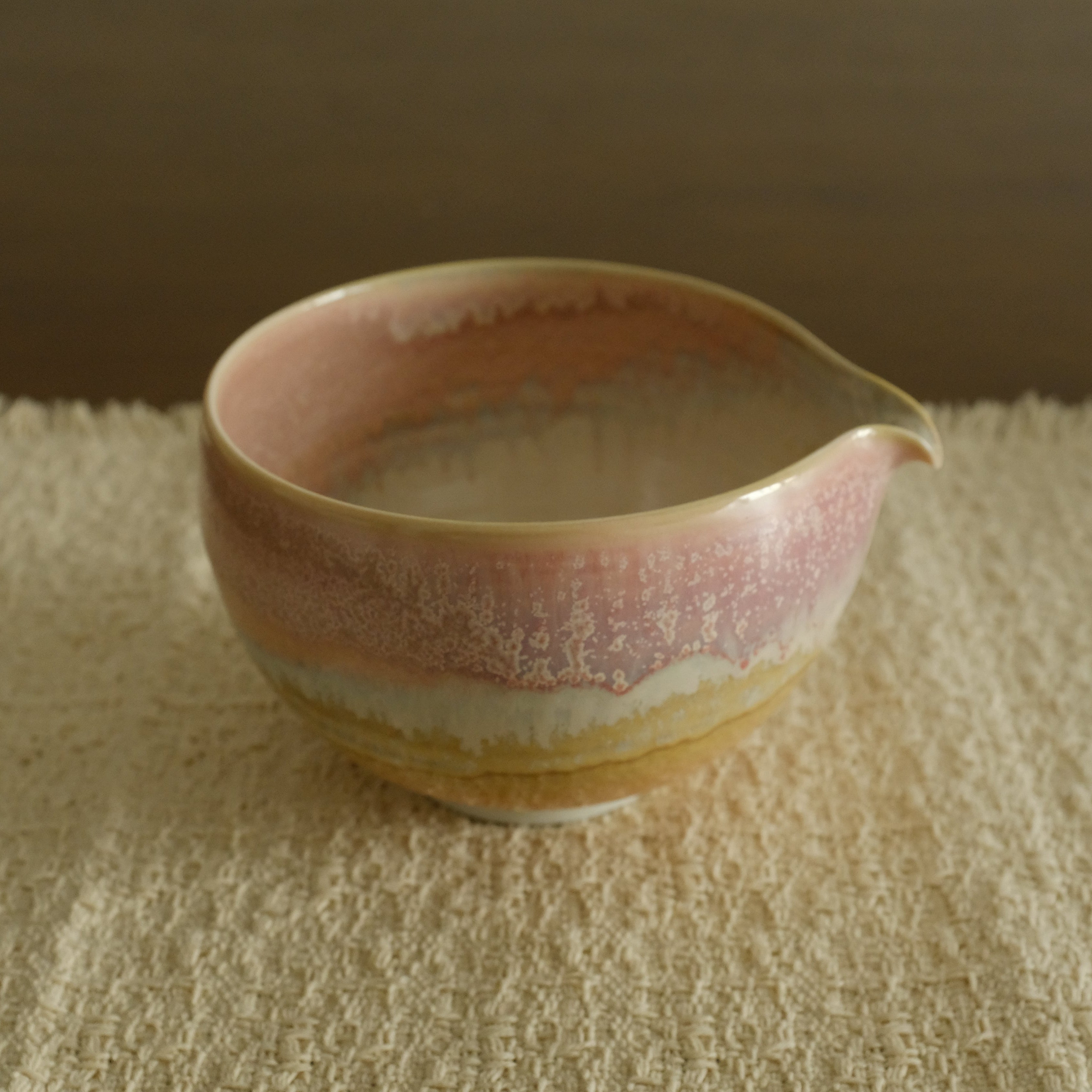 Ceramic bowl with a gradient finish on a textured surface