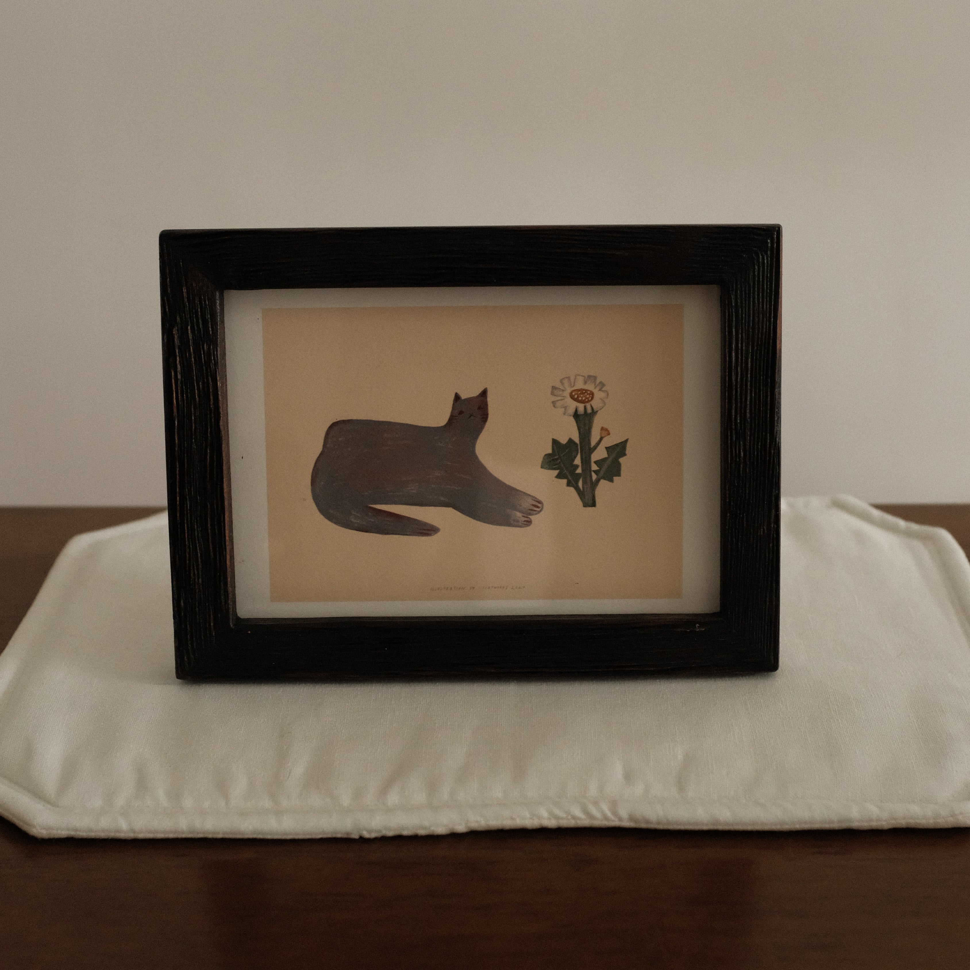 Teak Wood Framed artwork with a cat silhouette and flower on a white surface