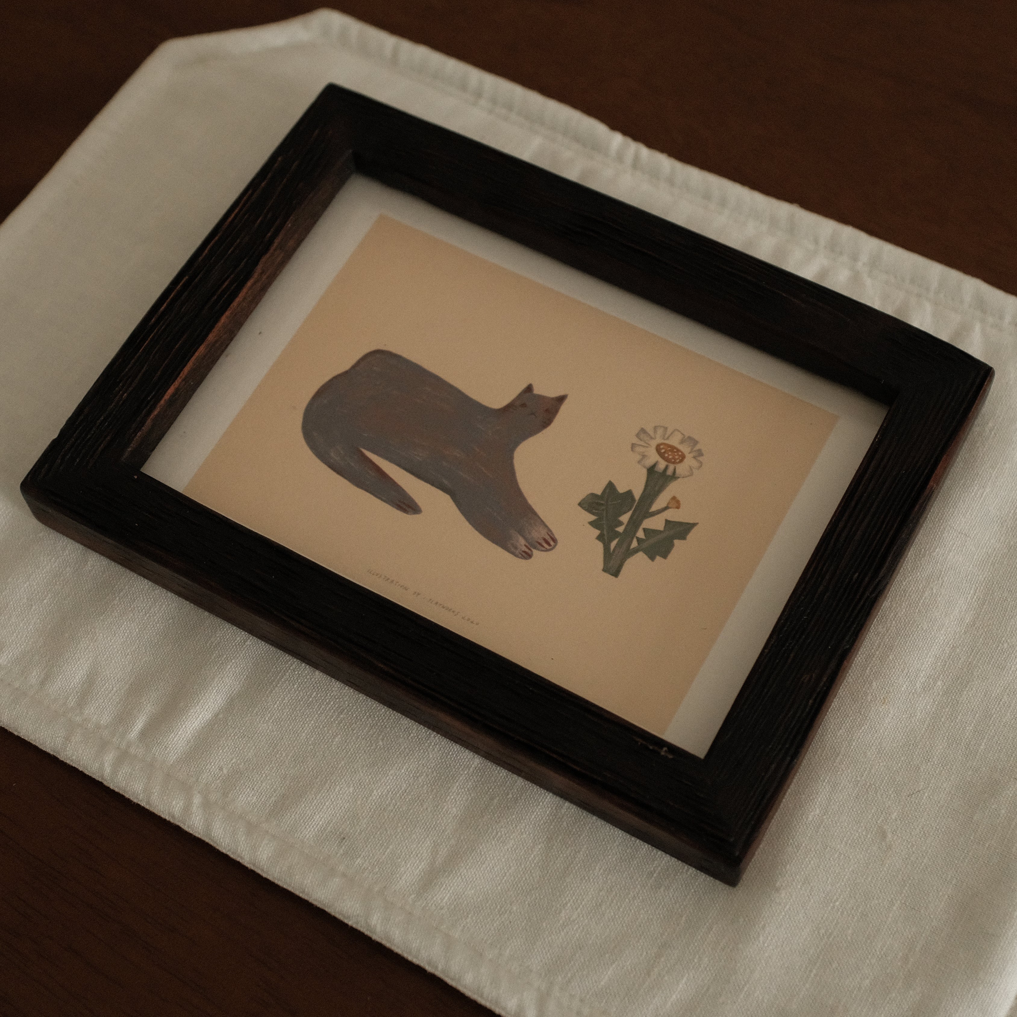 Teak Wood Framed artwork with a cat silhouette and flower on a white surface