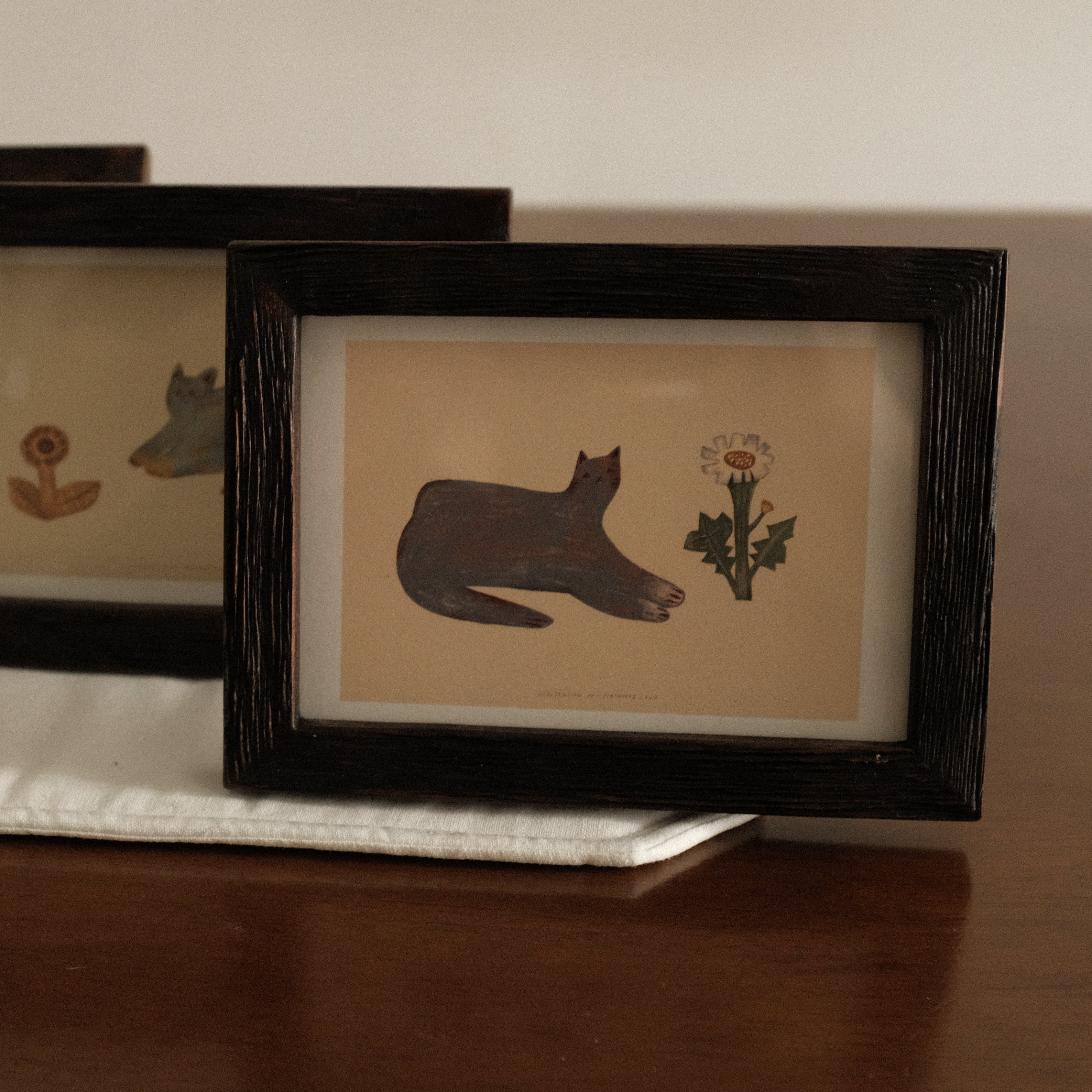 Teak Wood Framed artwork with a cat silhouette and flower on a white surface