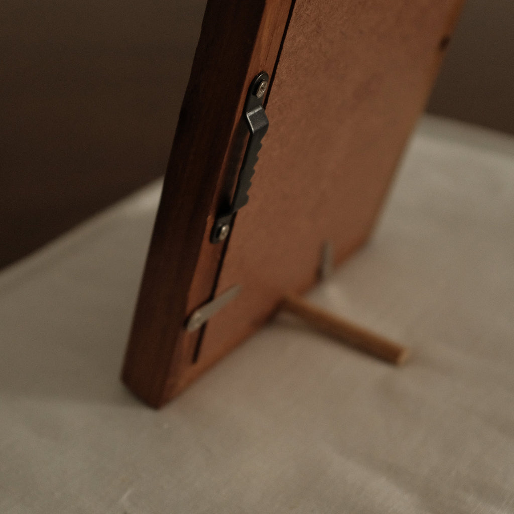 Wooden object on a white surface with a brown background