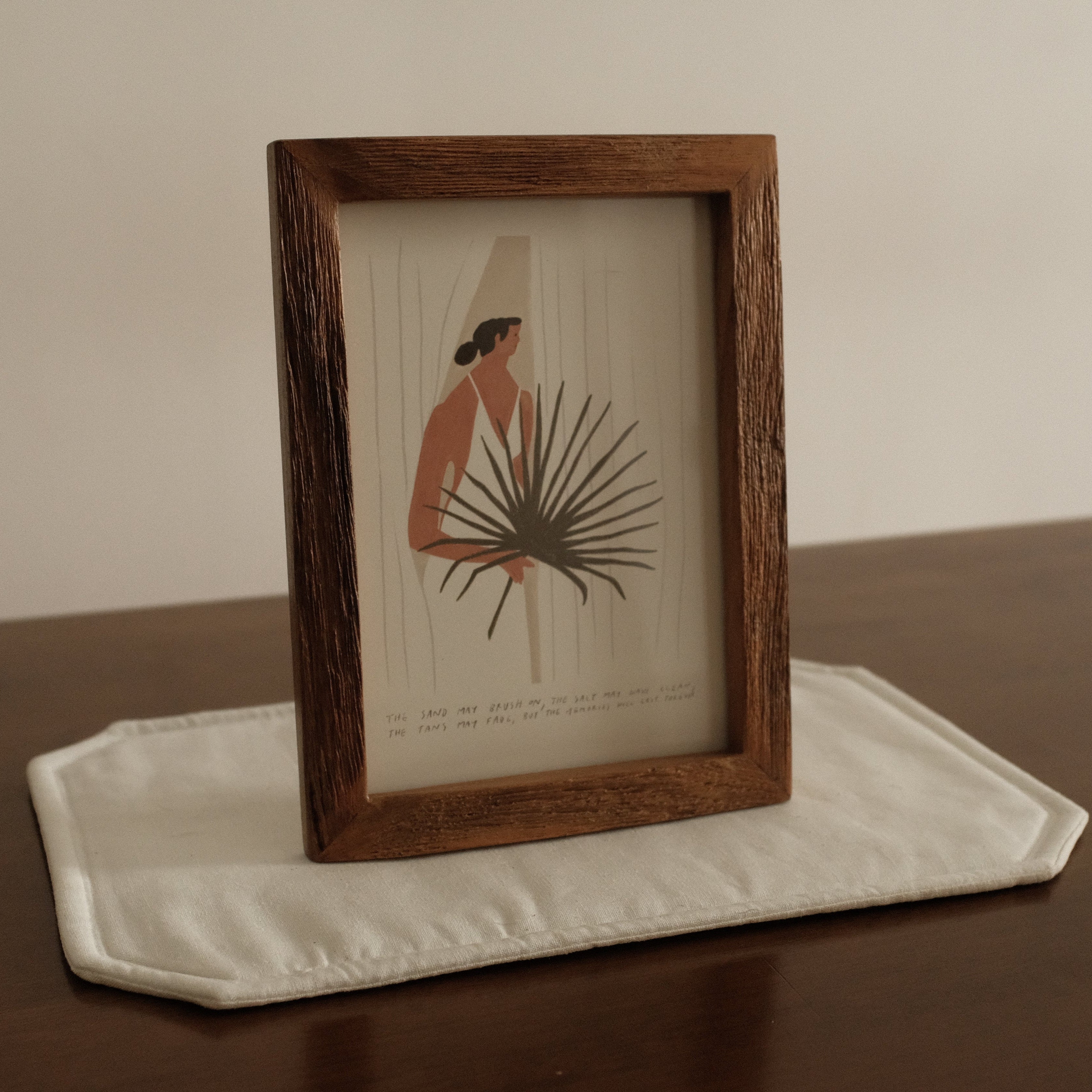 Framed artwork on a table with a neutral background