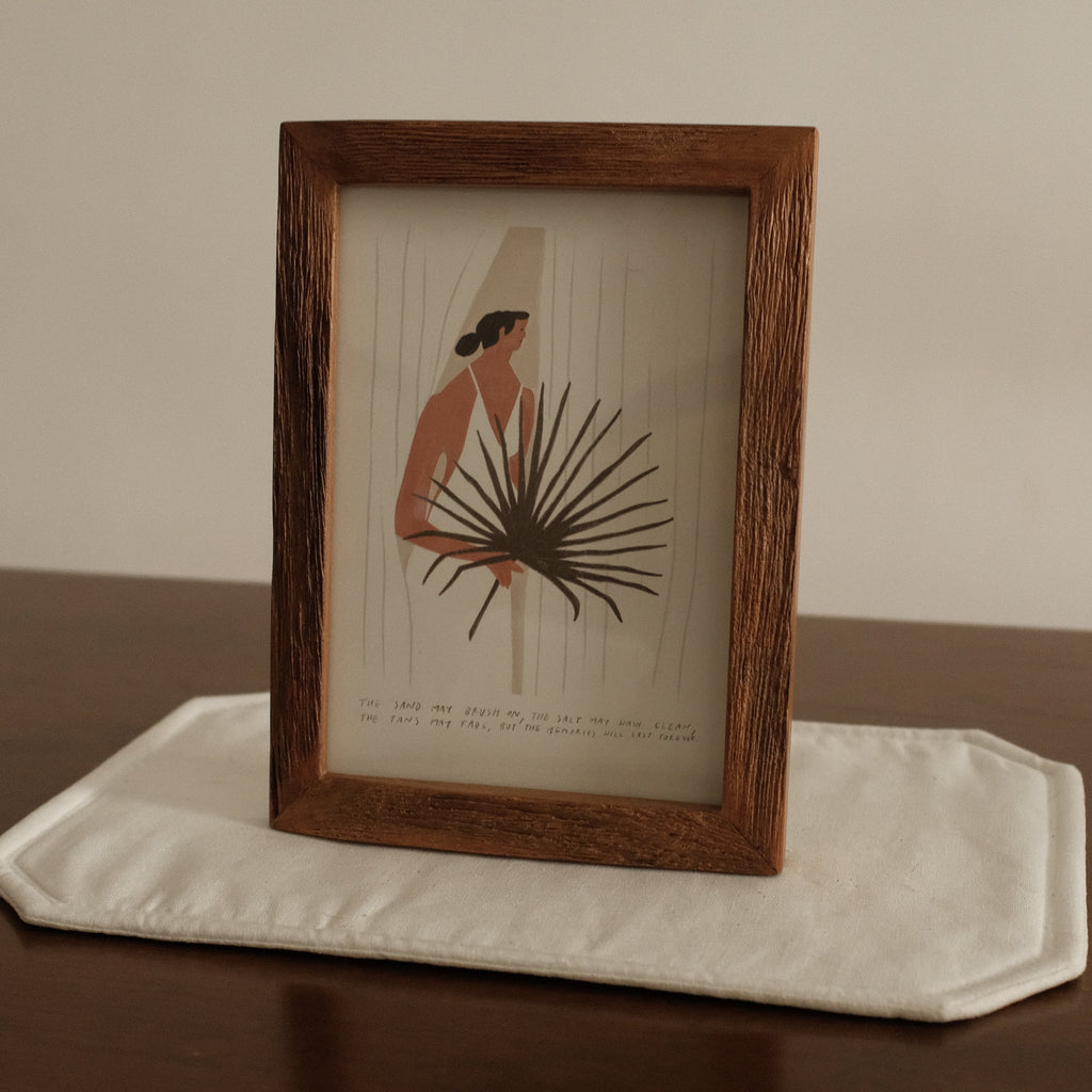 Framed artwork on a white stand with a plain background