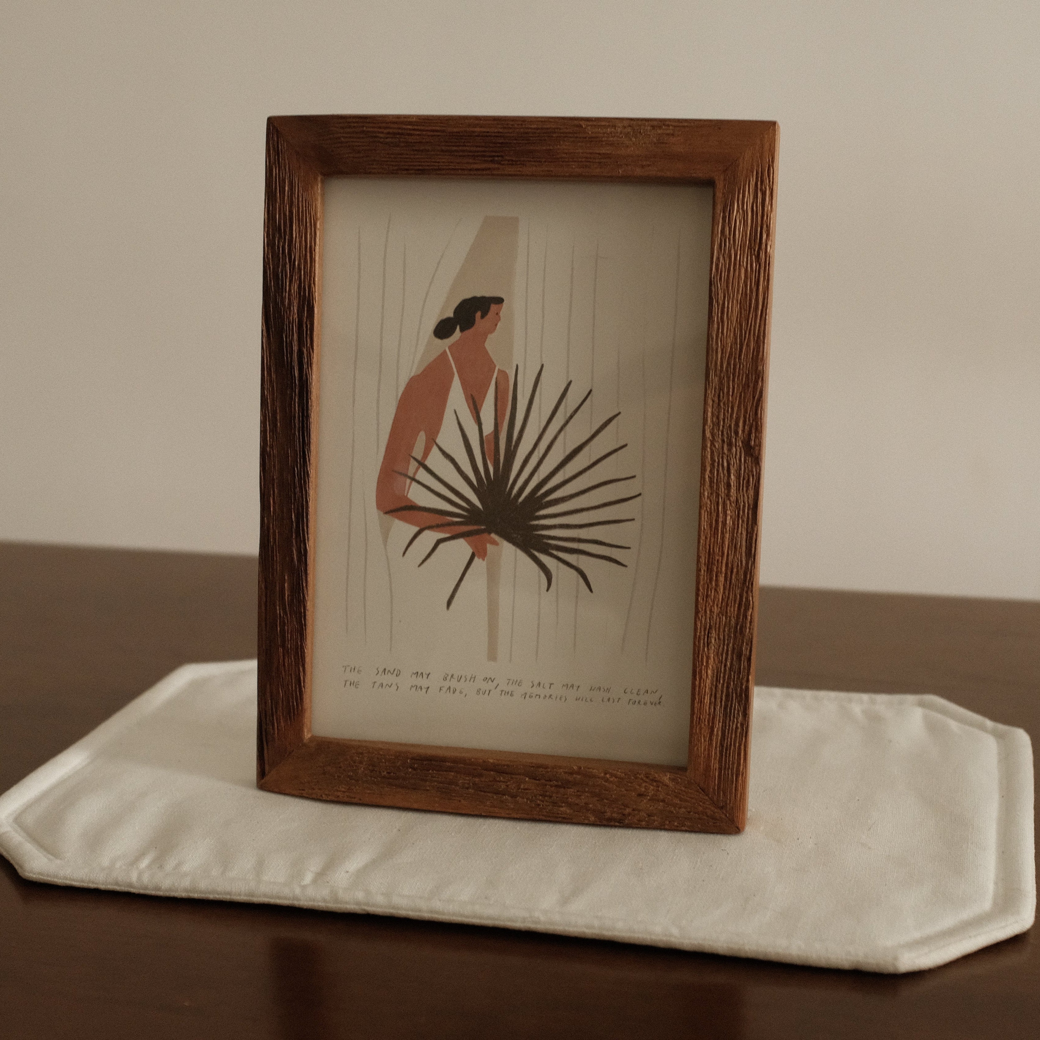 Framed artwork on a white stand with a plain background
