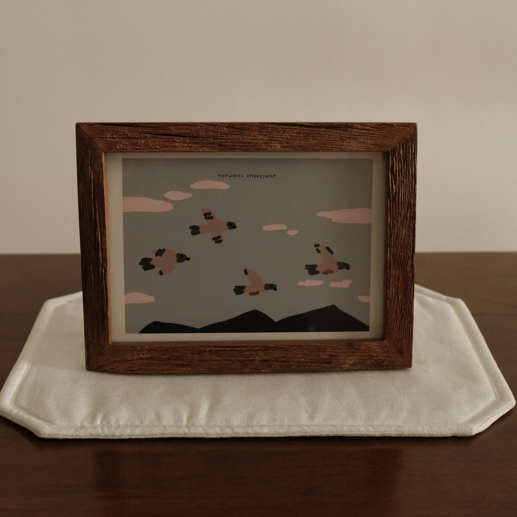 Teak wood Framed artwork on a wooden surface with a neutral background