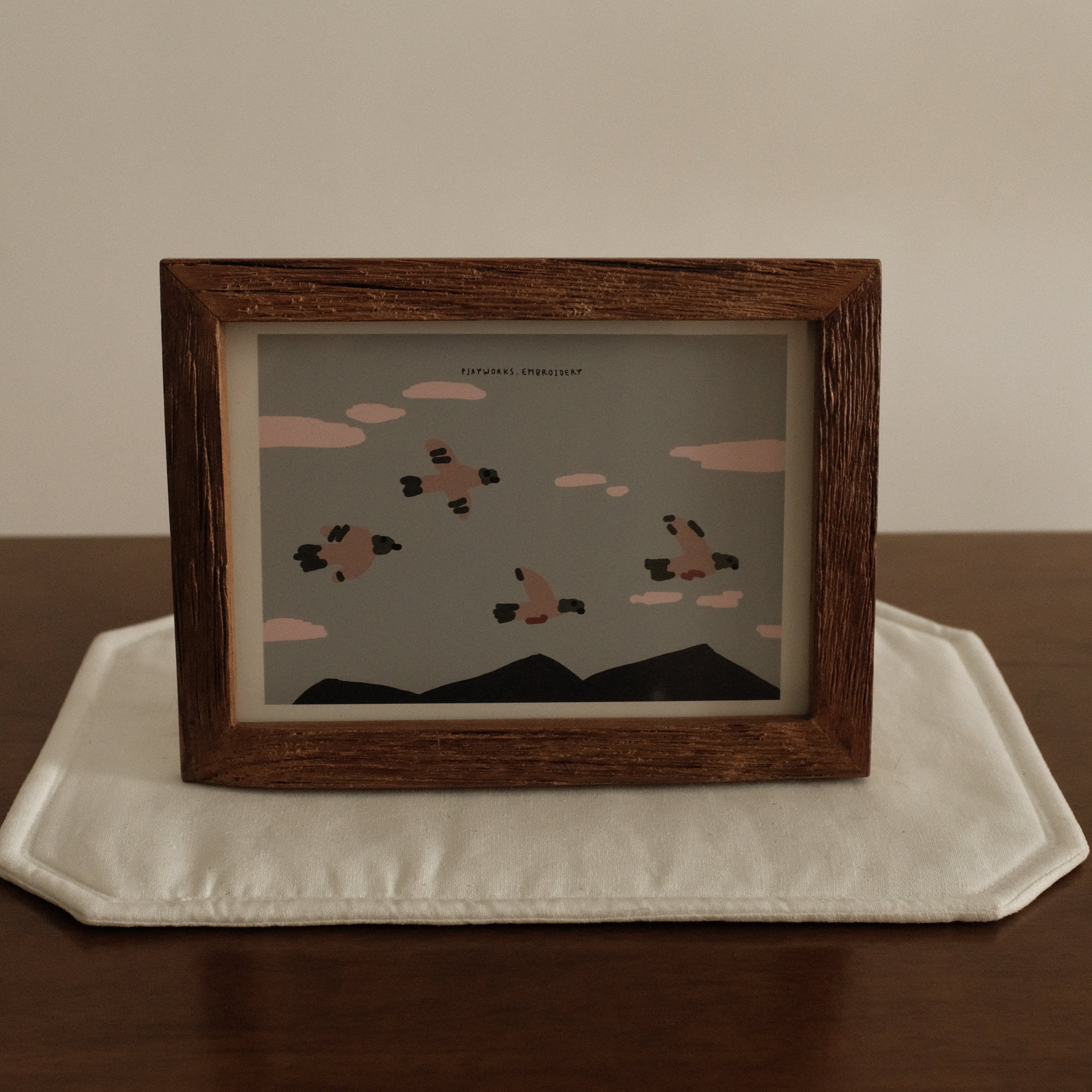 Teak wood Framed artwork on a wooden surface with a neutral background