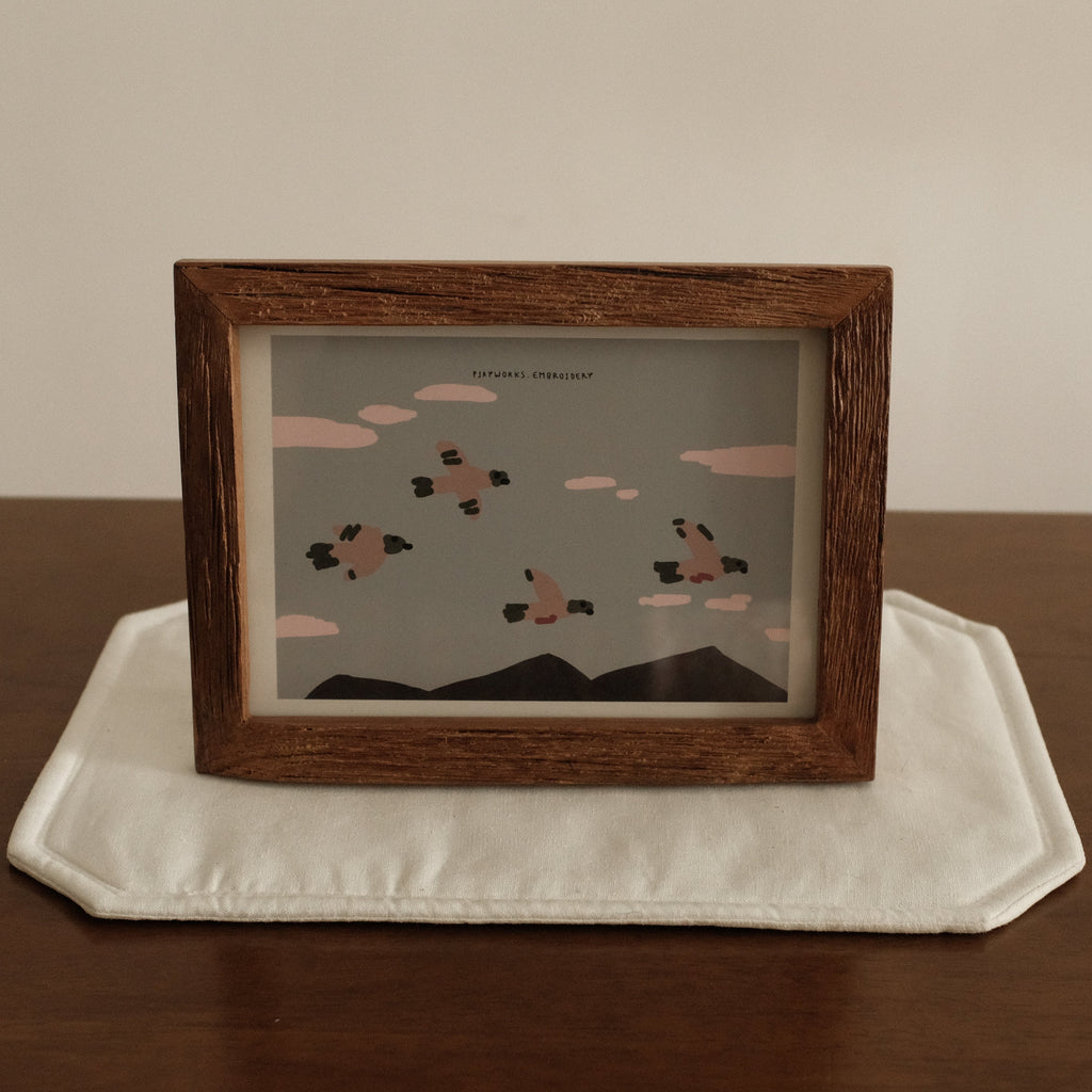 Teak wood Framed artwork on a white plate with a wooden frame