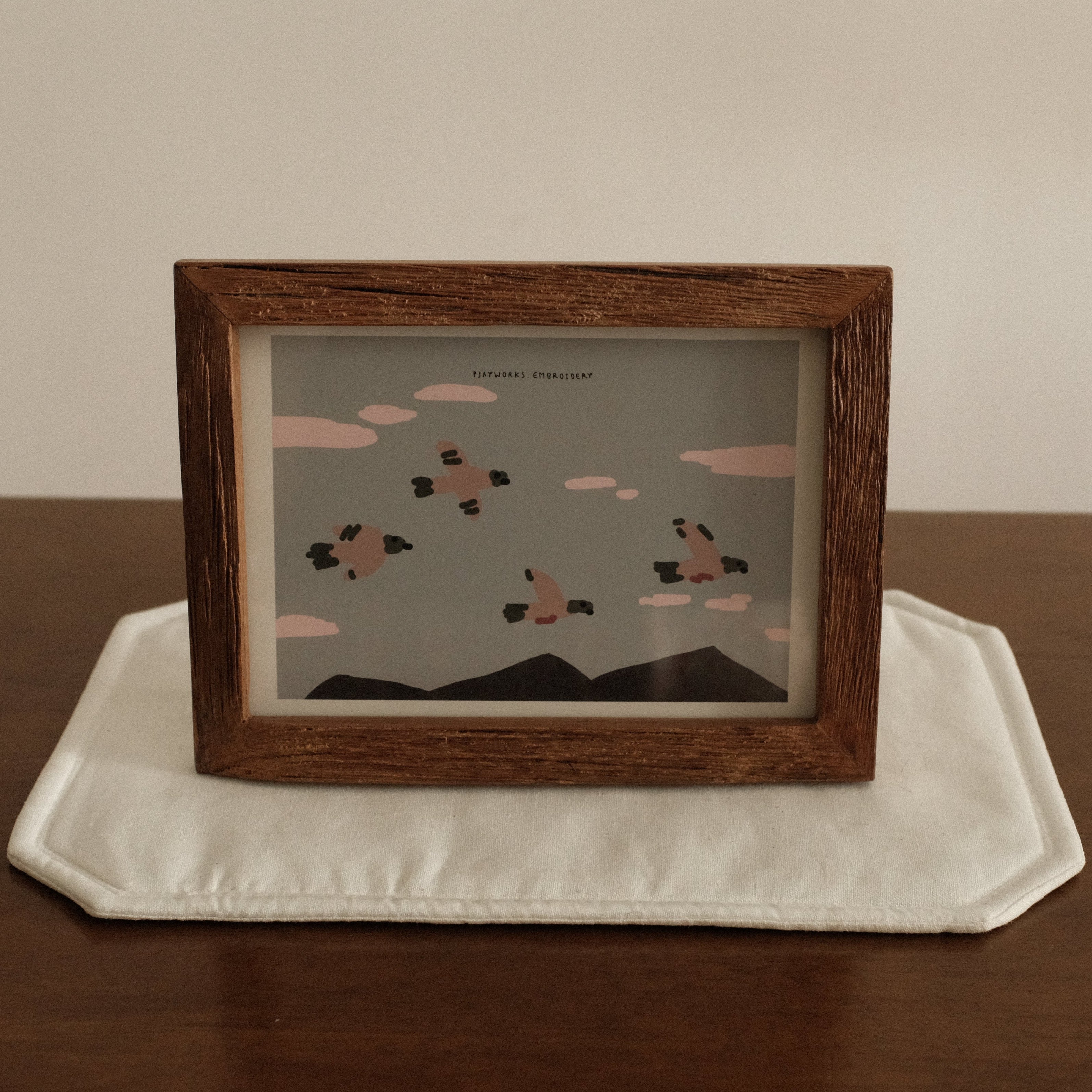 Teak wood Framed artwork on a white plate with a wooden frame