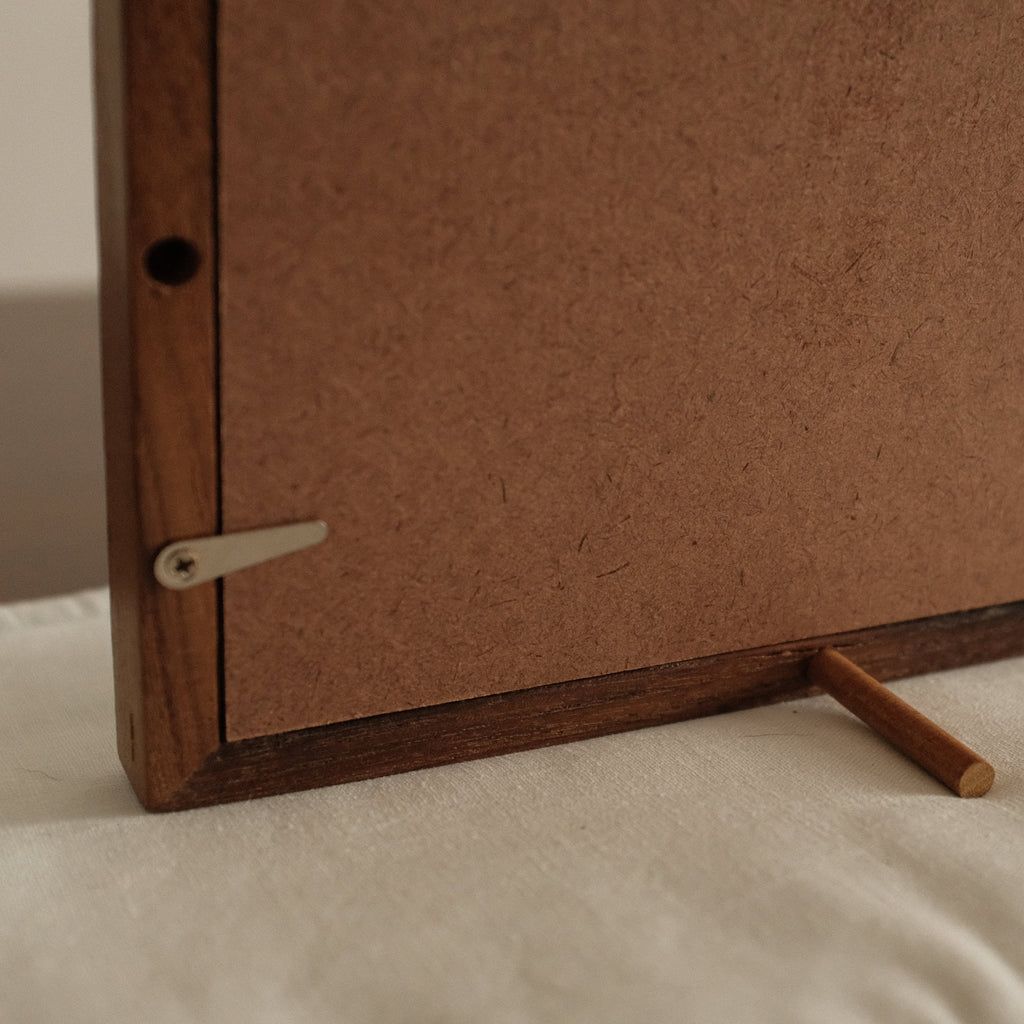 Back side of teak wood artwork Wood frame on a beige surface