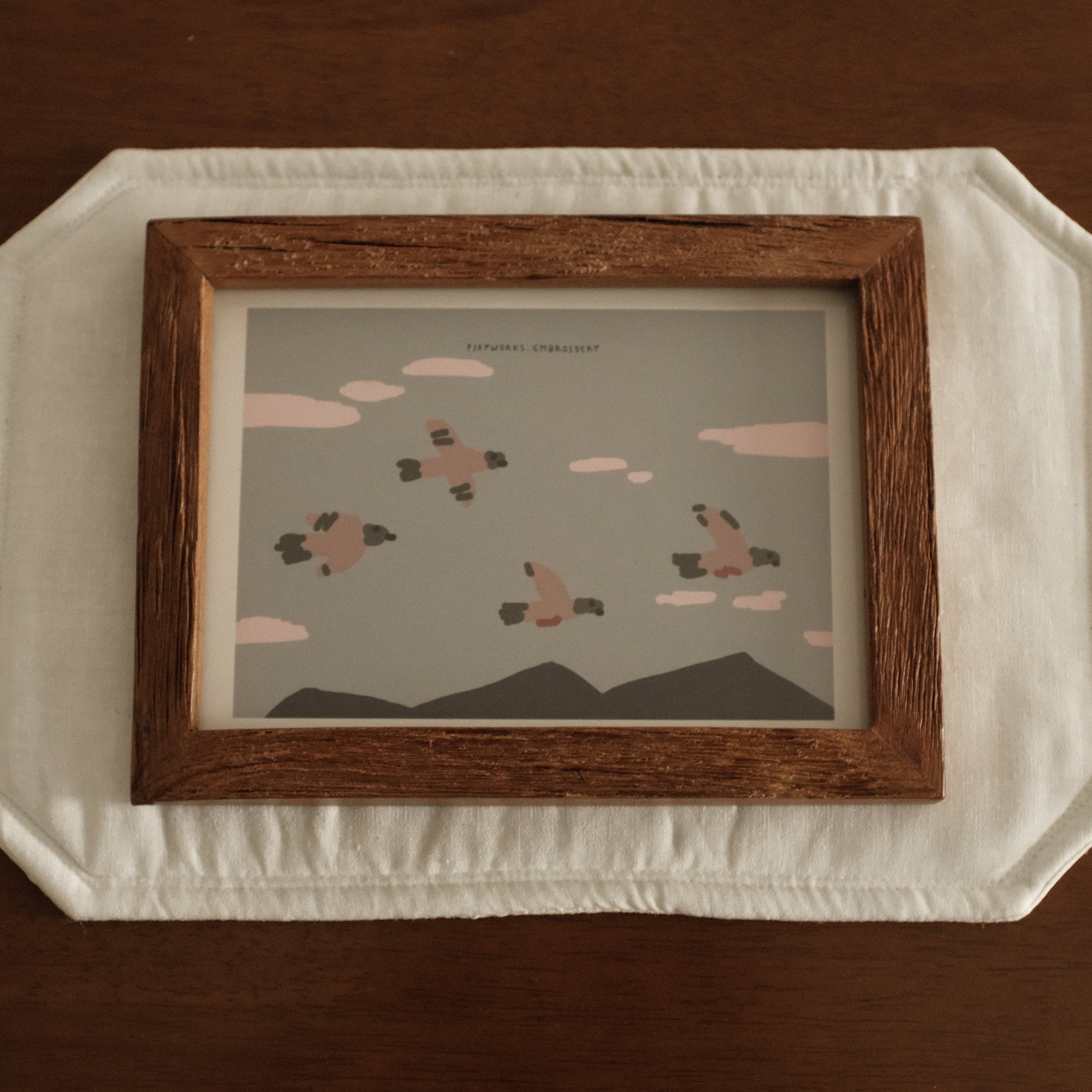 Teak wood Framed artwork on a textured surface with a brown background