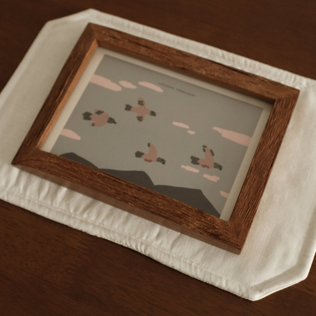 Teak Wood Framed artwork on a white surface with a wooden frame