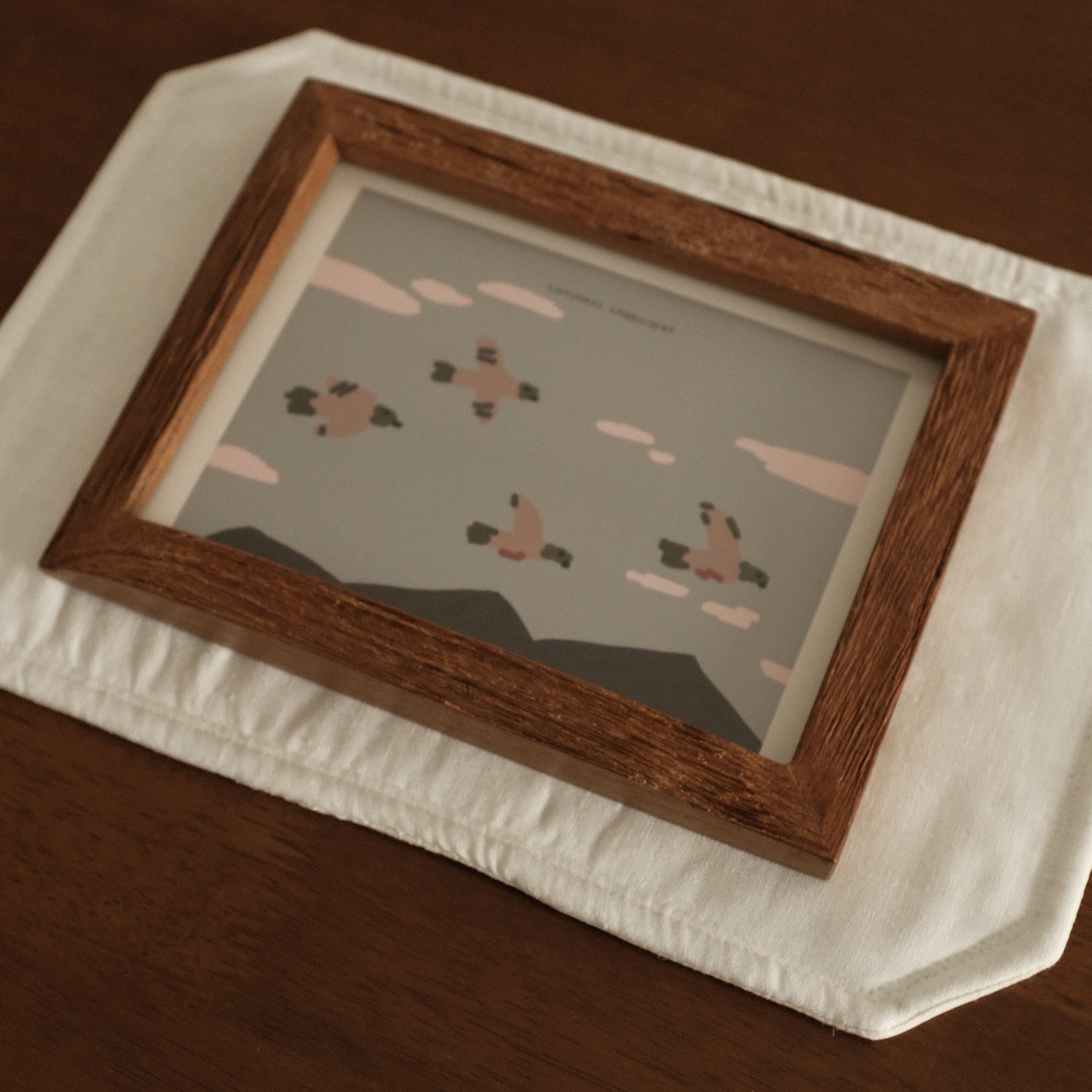 Teak Wood Framed artwork on a white surface with a wooden frame