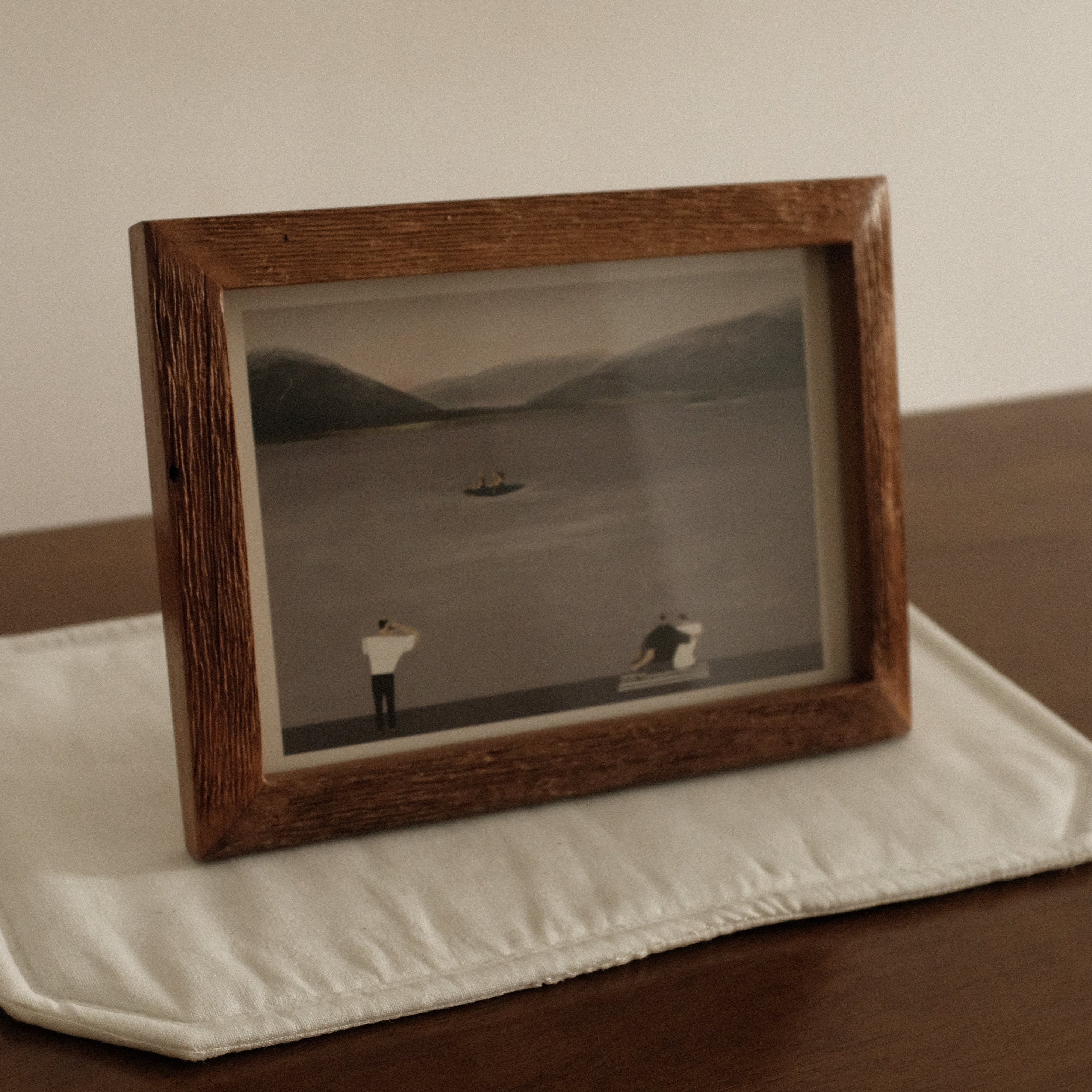 Teak Wood Framed Leisure by the Lake black and white photograph of a landscape with two figures on a wooden surface.