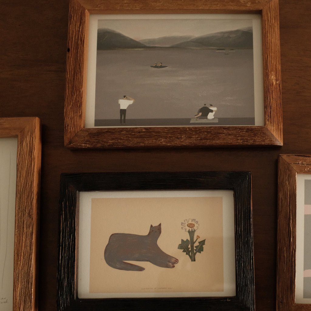 Collection of teak wood frame artworks on a wooden wall