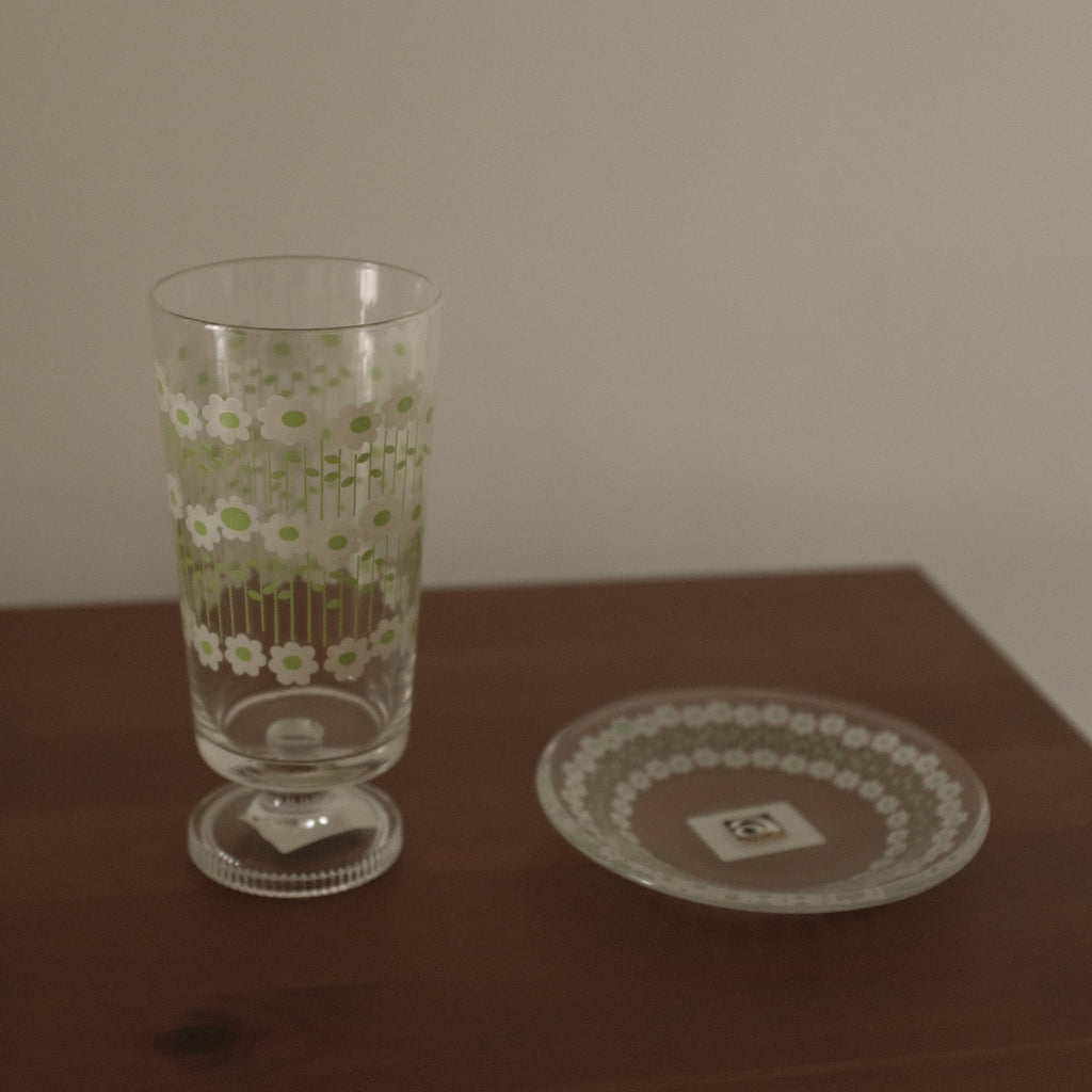 Glass with floral pattern on a wooden table
