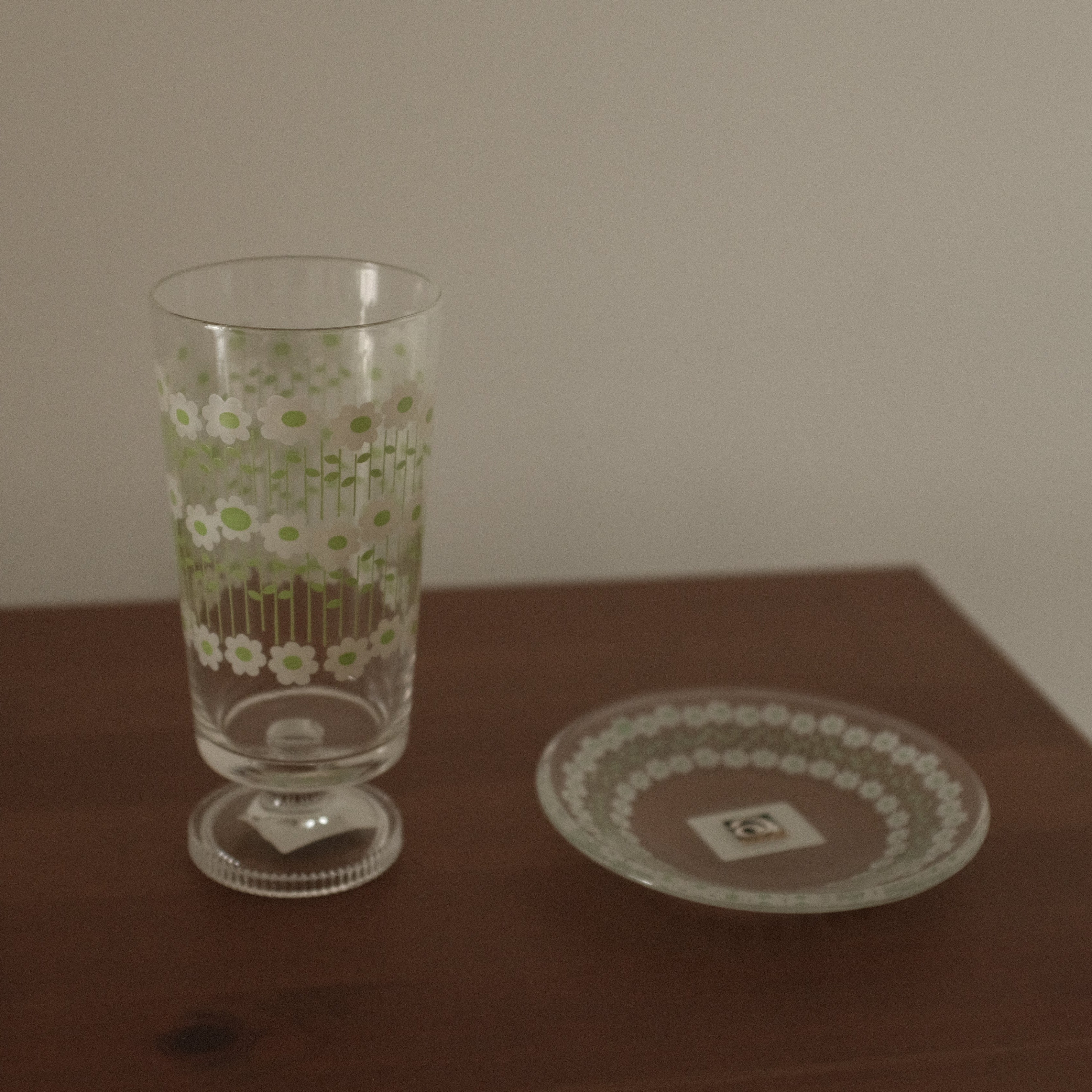 Glass with floral pattern on a wooden table